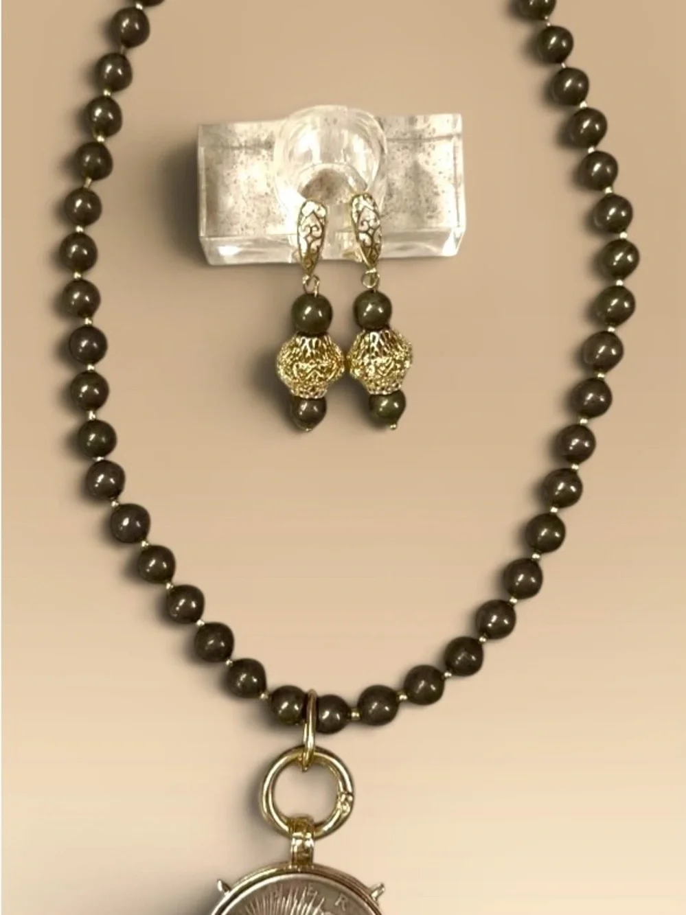 Large silver tone coin in gold tone setting on pyrite necklace with earrings